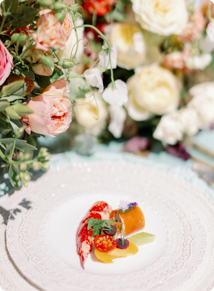 luxury dining dish on white plate surrounded by flowers