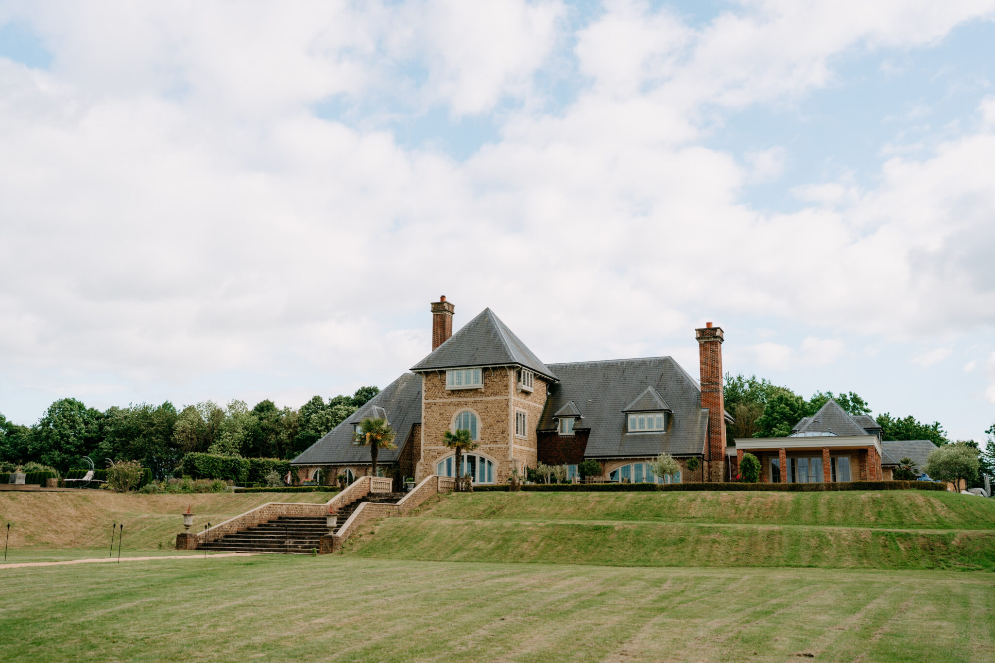 large lawn with country manor elevation