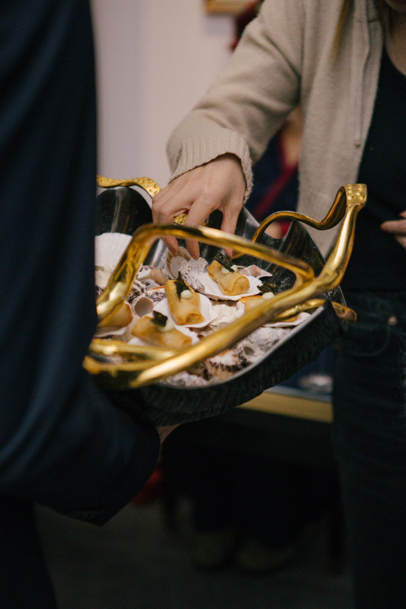 hands taking canapes from bowl