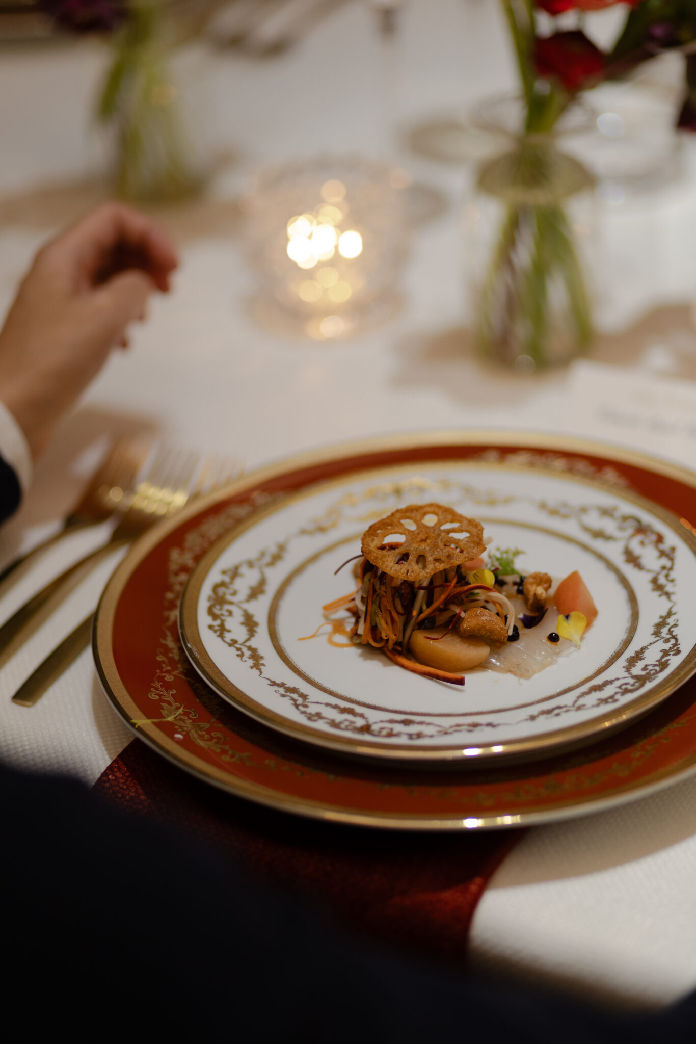 red and white plates with gold detail and dish with lotus plant