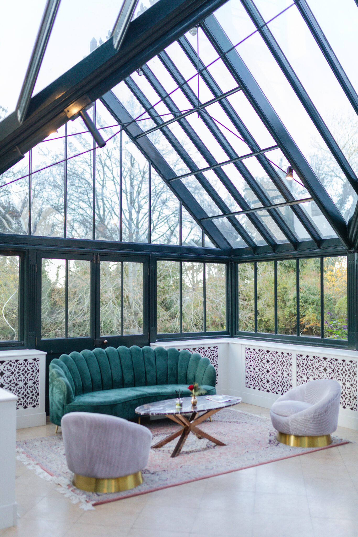 green sofa grey arm chairs in orangery